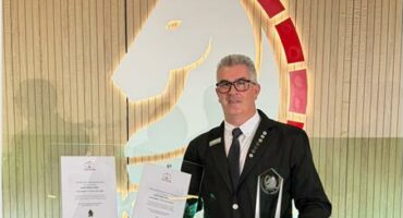 Man standing with trophy