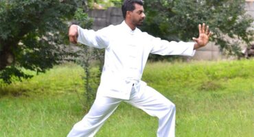 Indian man in white in a posed stance