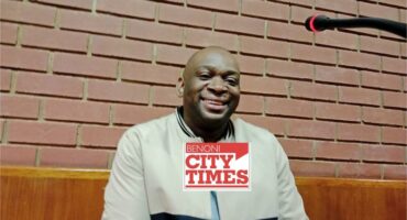 Black man smiling at the camera