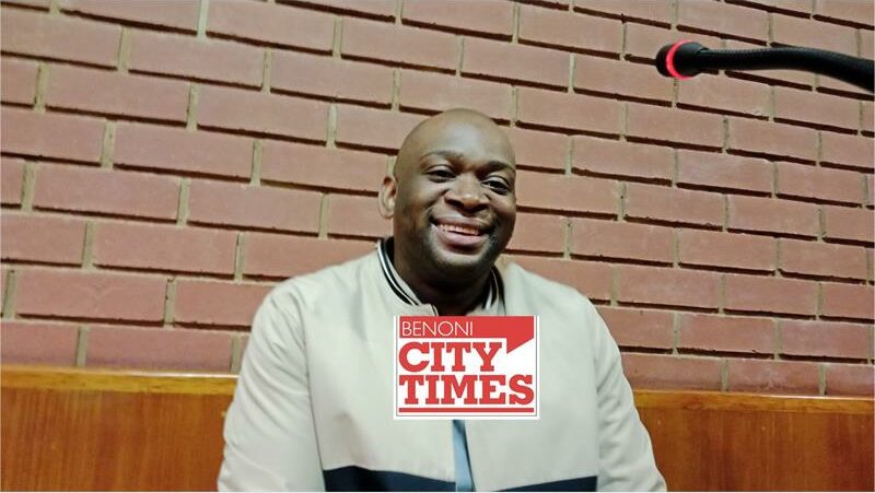 Black man smiling at the camera