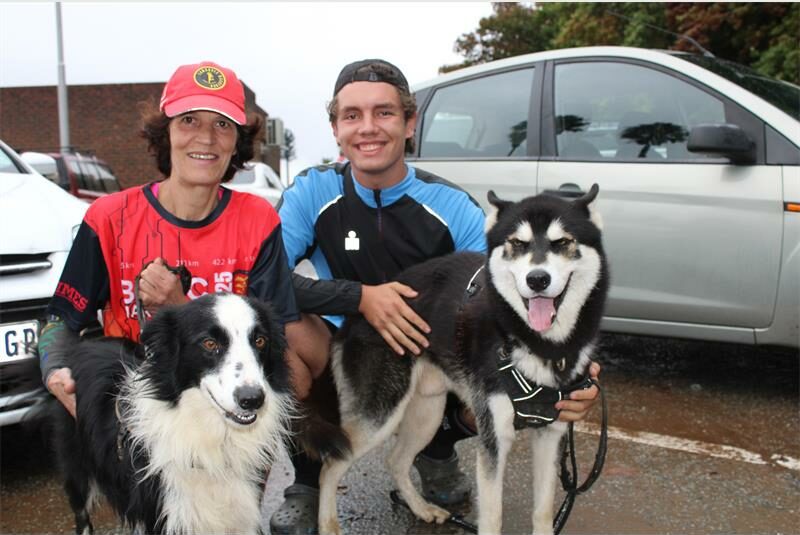 Woman and man in running gear with two dogs