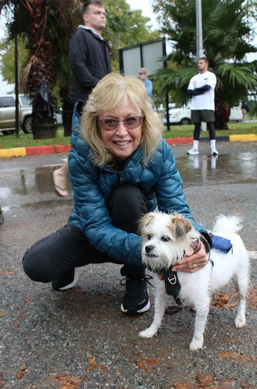 Woman with glasses with a white dog