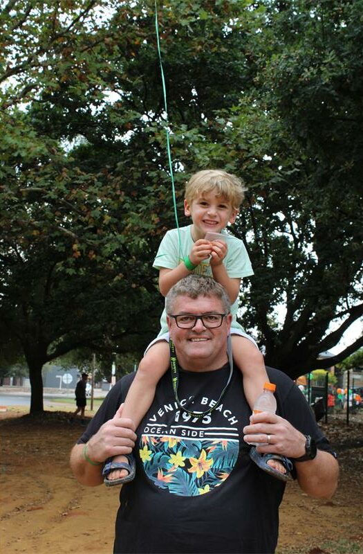 Man with a child on his shoulders