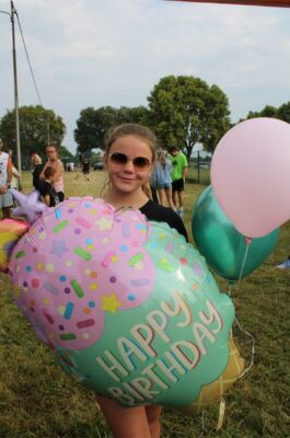 Girl holding balloons