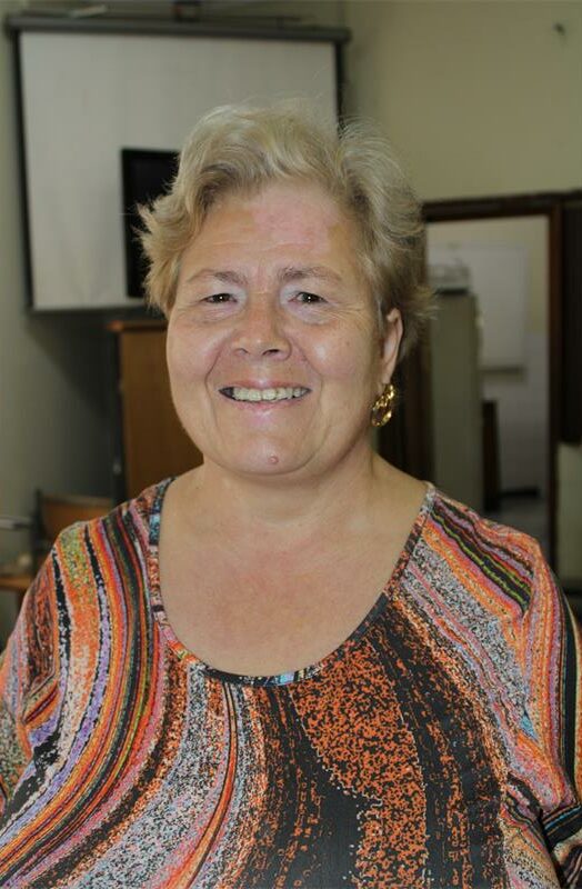 White woman wearing an orange and brown dress