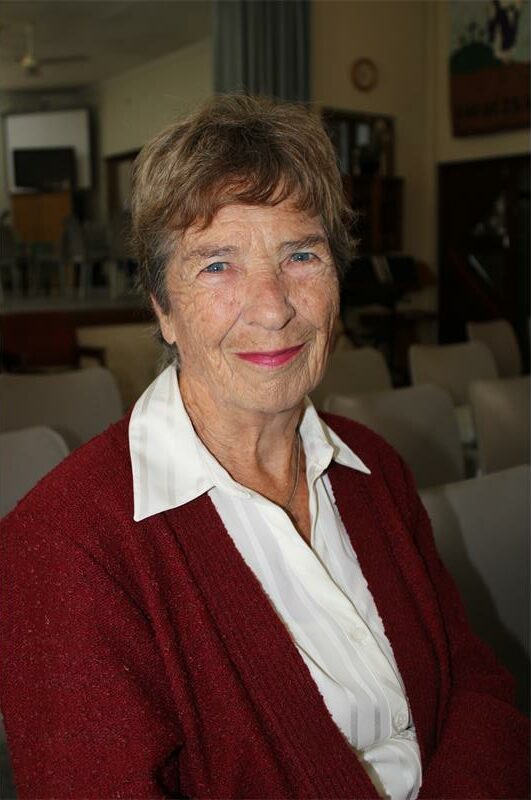 Elderly white woman wearing a red jersey