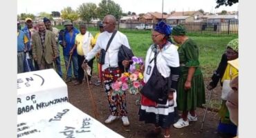 two old people holding a flower basket