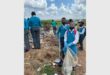 children picking up garbage,wearing school uniform.