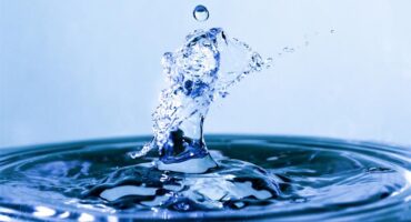Drop of water splashing into a body of water