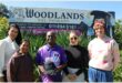 Four women and a man standing in front of a Woodlands school board.