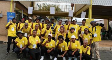 Group of youths wearing matching yellow shirts