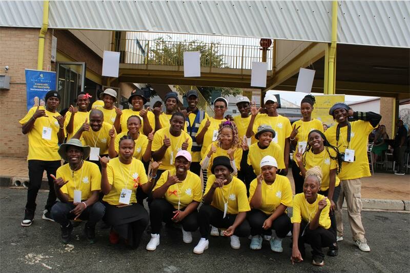 Group of youths wearing matching yellow shirts