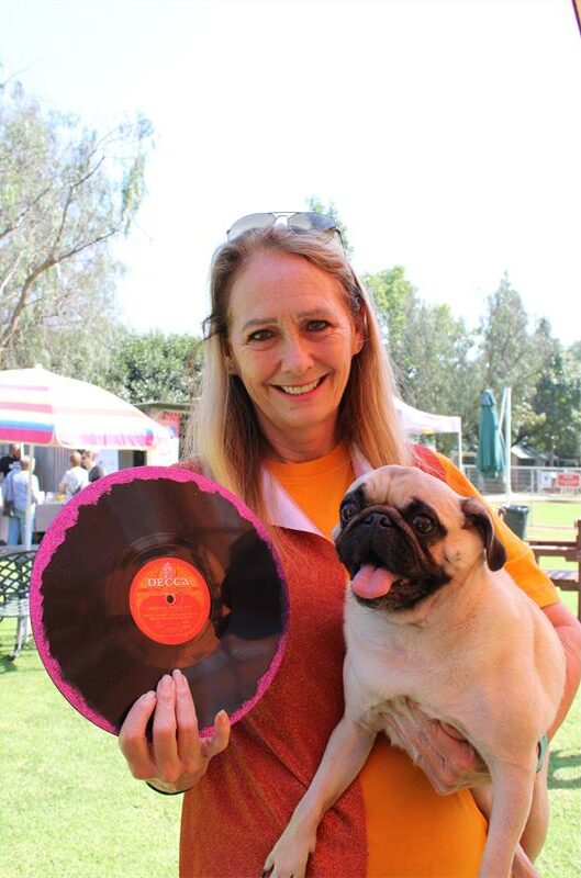 Woman hold a LP and a drown pug