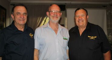 Three elderly men smiling