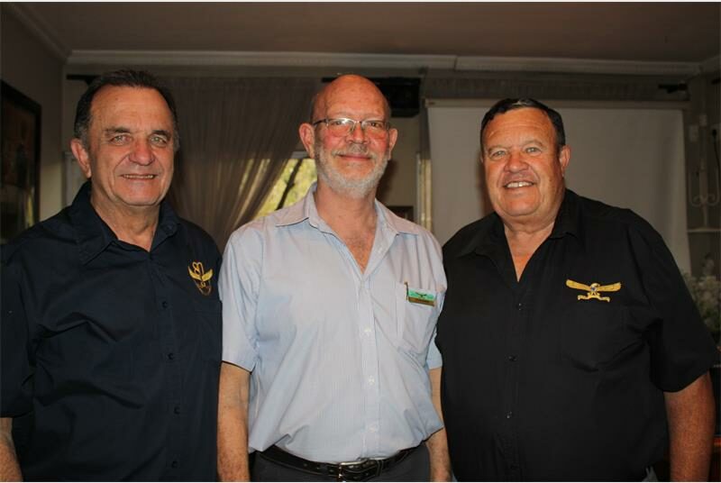 Three elderly men smiling