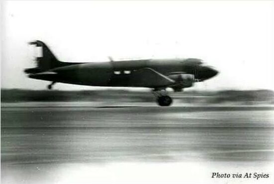 Black and white picture of a plane with a damaged tail landing