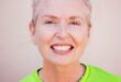 White woman smiling at the camera