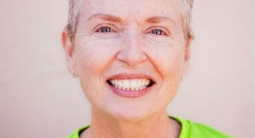 White woman smiling at the camera