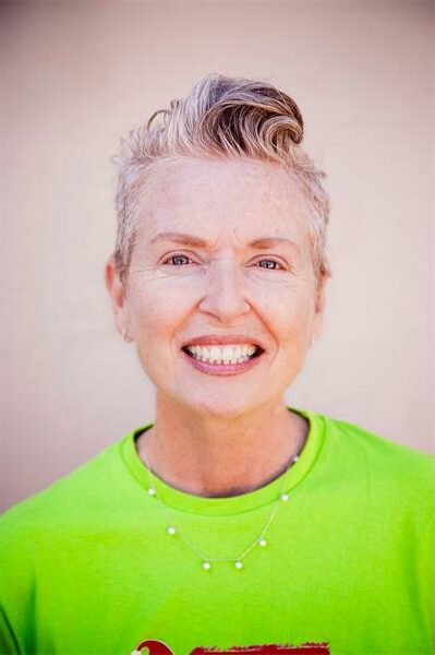 White woman smiling at the camera