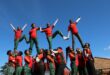 Group of black girls in uniform making an aerial cheerleading formation