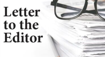 A black and white image of reading glasses on top of a pile of papers and a pencil next to this with the wording Letter to the Editor.