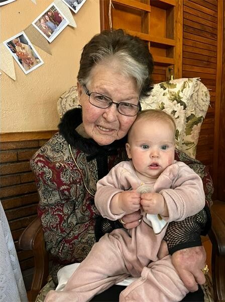Elderly woman holding a baby