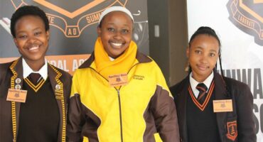 Three female learners in uniform