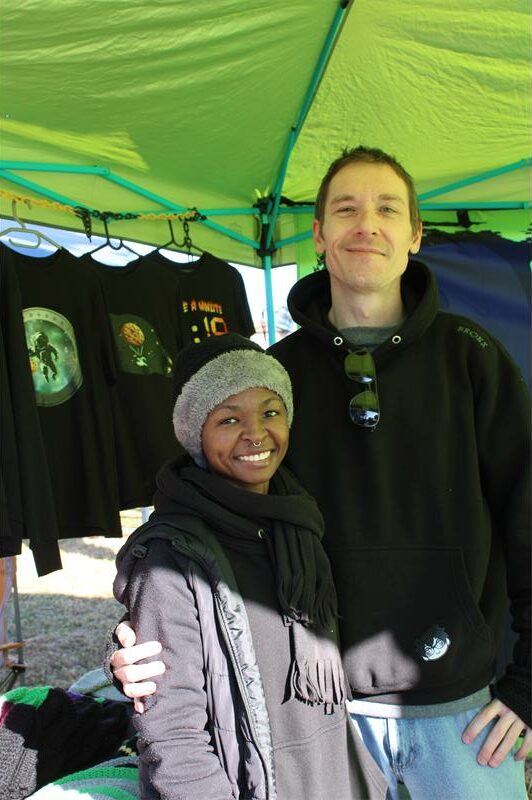 Tall white man holding a short black woman