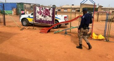 Uniformed officer walking next to playground equipment