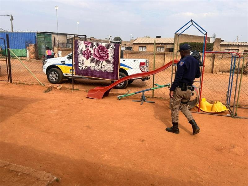 Uniformed officer walking next to playground equipment