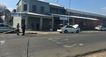 Accident scene in front of an old grey building