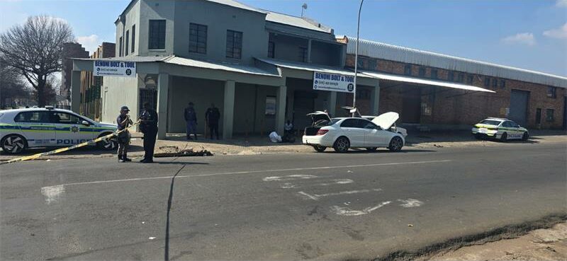 Accident scene in front of an old grey building