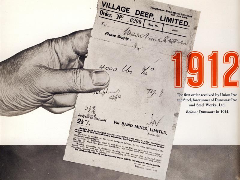 A black and white image of a hand holding an order form with the number 19 in orange on the image.
