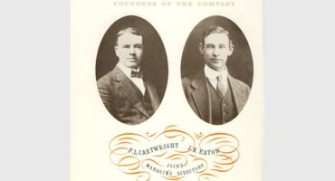 A black and white image of two white men taken in the early 19203 displayed in frames.
