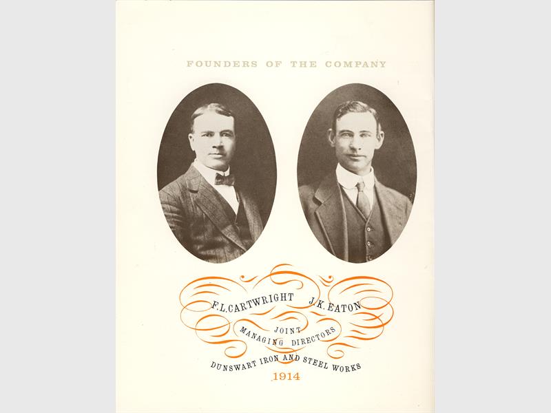 A black and white image of two white men taken in the early 19203 displayed in frames.