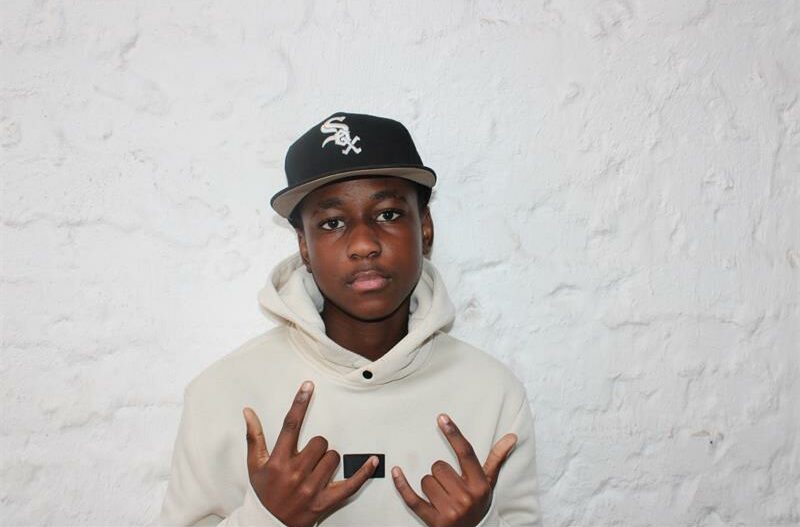 Young black man with a black had showing finger signs