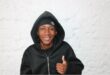 Young black man with a hoodie showing a thumbs up