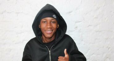 Young black man with a hoodie showing a thumbs up
