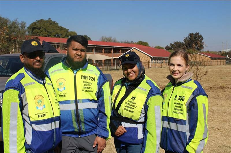 Four people, two men and two women wearing reflective jackets