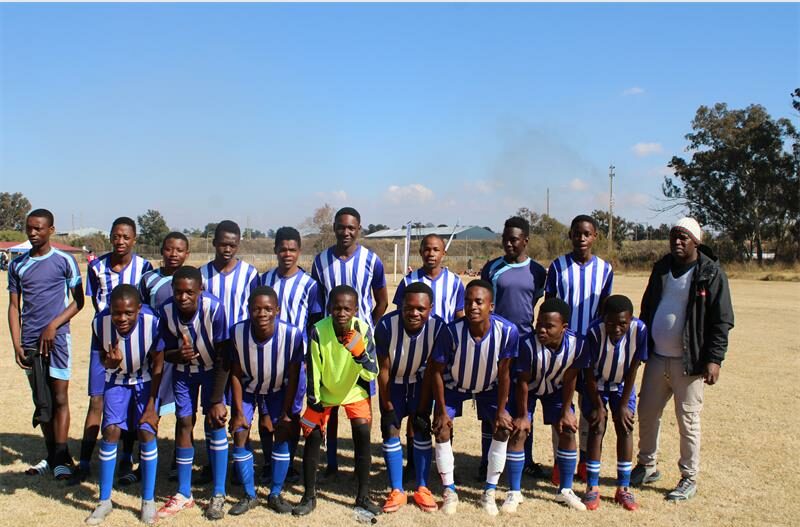 Team of football players wearing blue and white striped strips