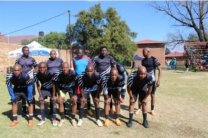 Group of black men wearing football strips