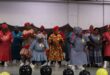 Black women in colourful attire dancing on stage