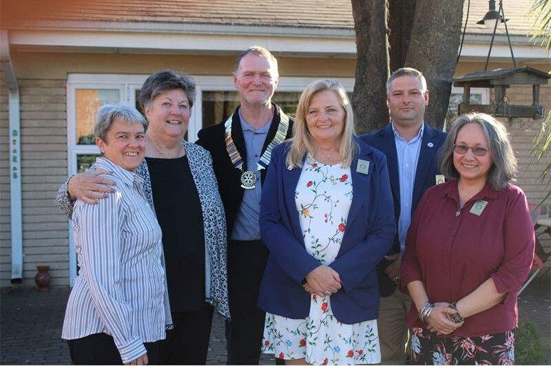Group of people standing in a garden setting
