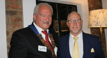 Two elderly men standing next to each other