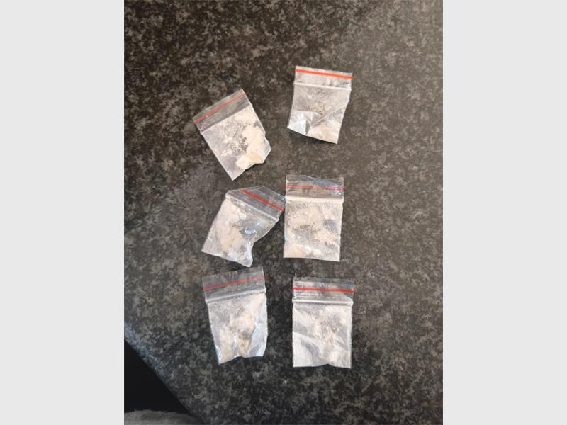 Packages of drugs photographed on a table.