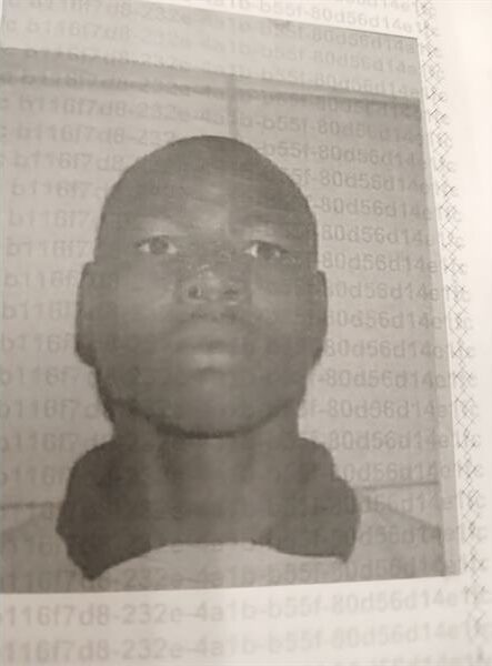 Black and white mug shot of a bald black man