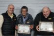 Two men holding certificated standing next to a bald man