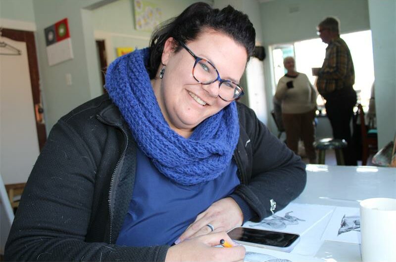 Woman smiles while drawing