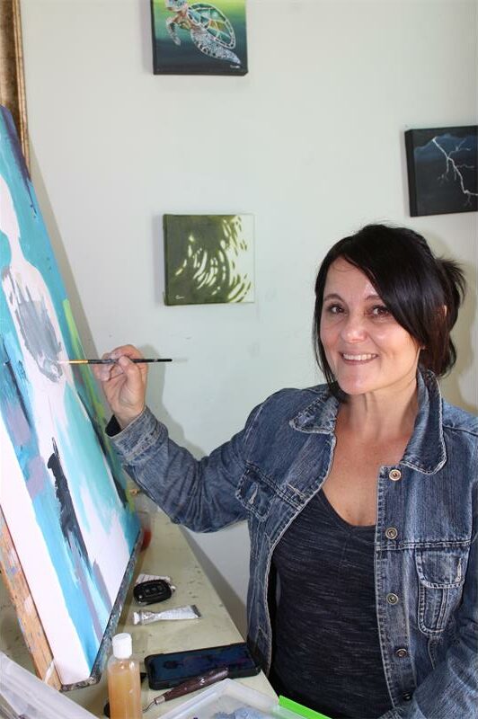 Woman painting on a large canvas