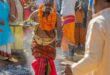 Man in traditional attire walking over coals